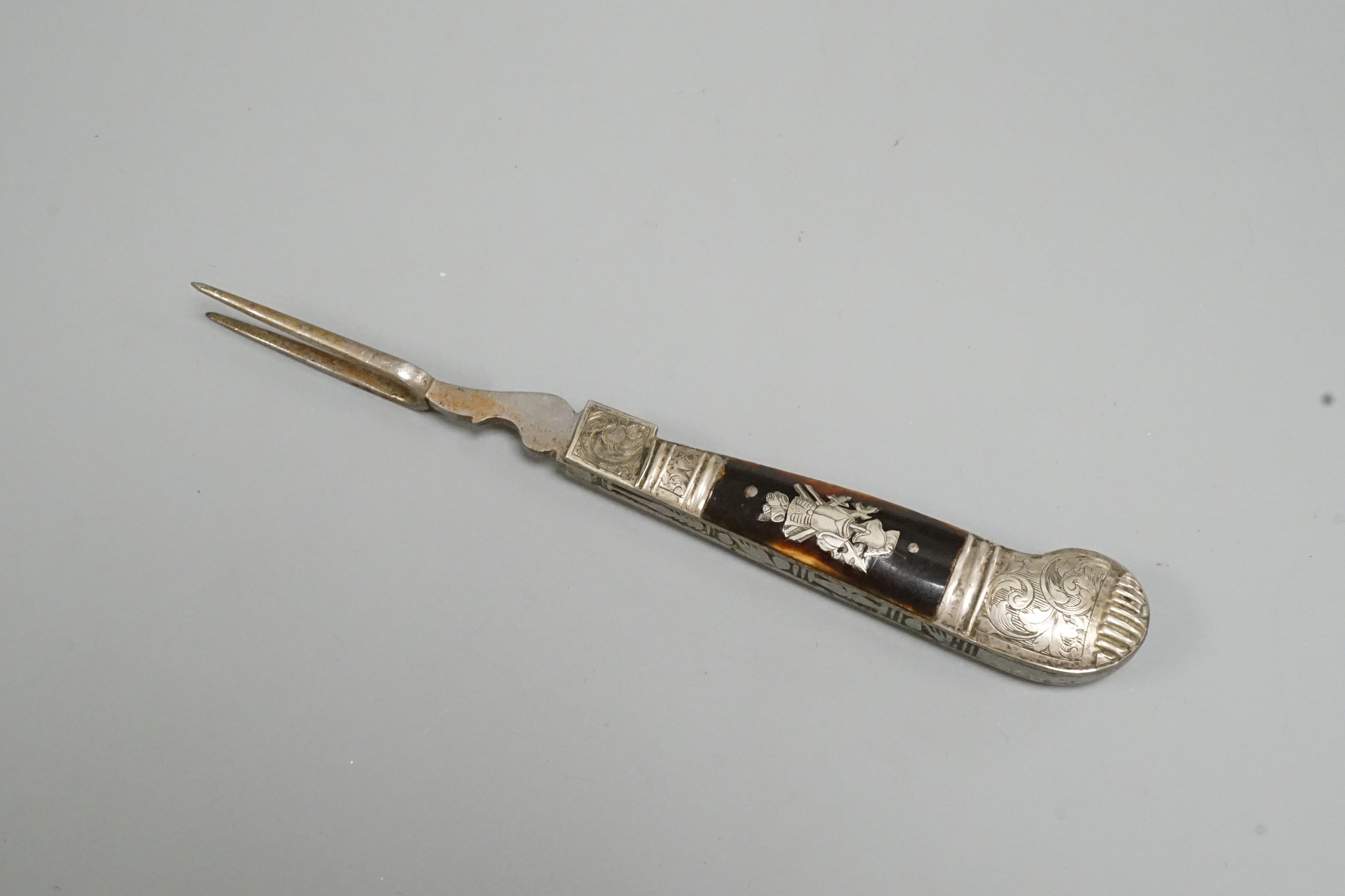 A 17th century white metal and tortoiseshell mounted pistol handled folding fork, 17.4cm.